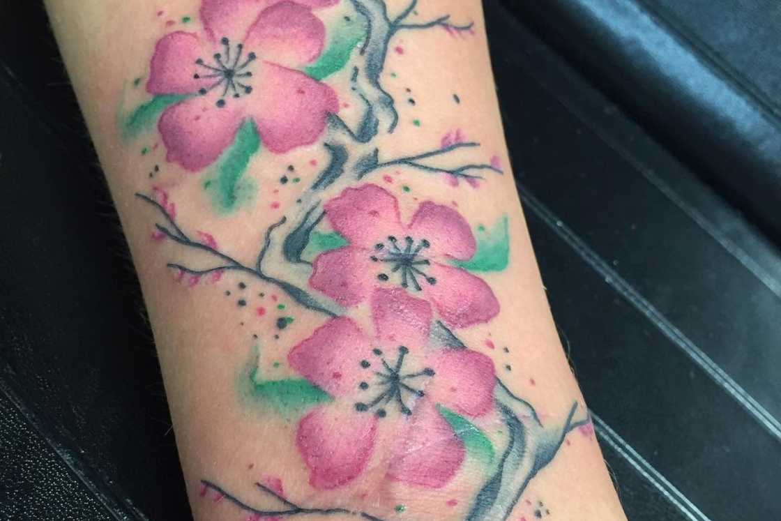 Little watercolor cherry blossoms on the fore arm