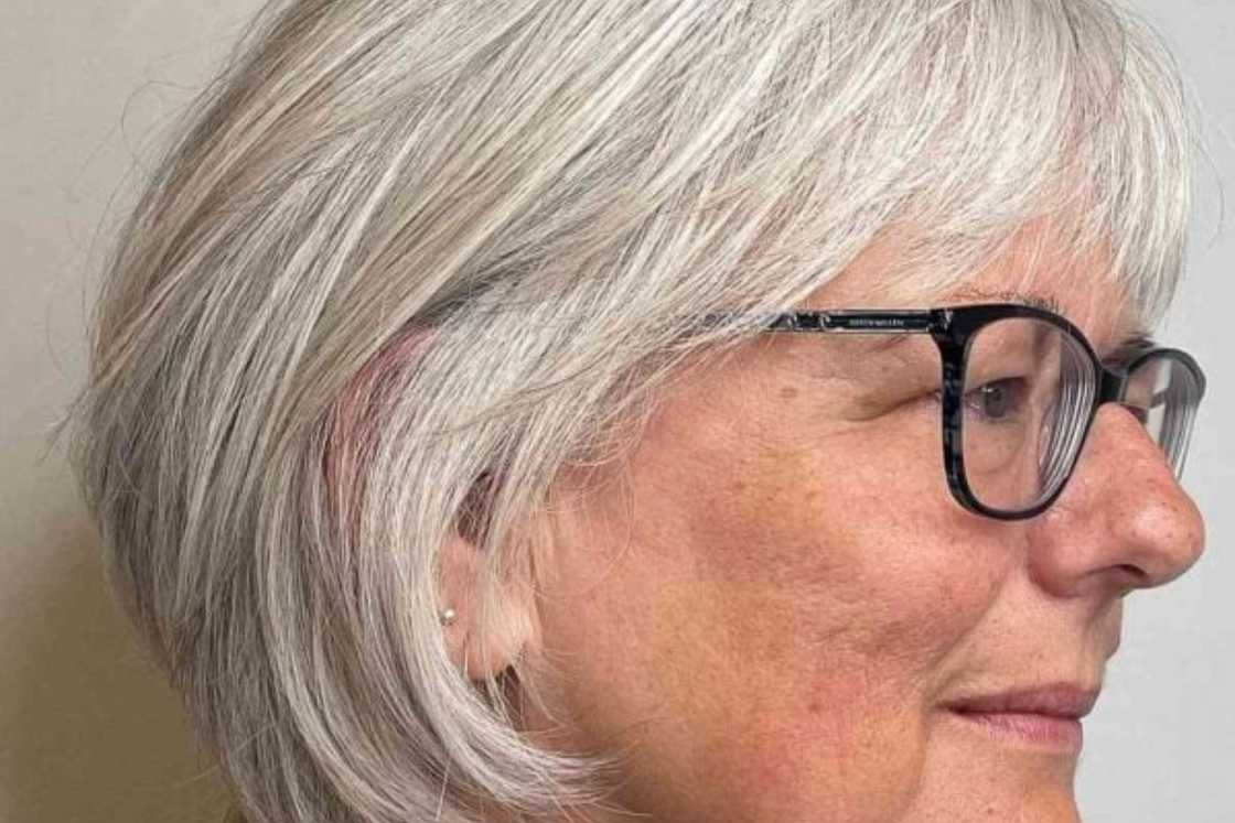 An old woman with feathered grey bob with glasses An old woman with feathered grey bob with glasses