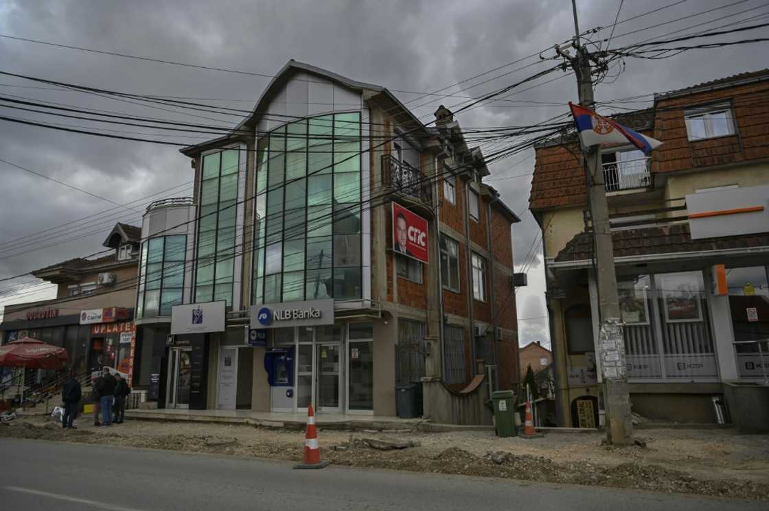 Kosovo Serbs stand in front of a bank in Gracanica, central Kosovo o