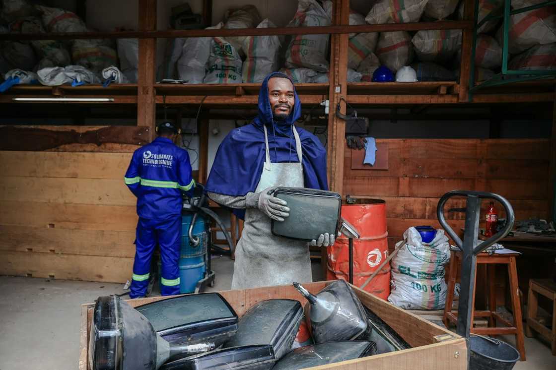 Yannick Ayi, a technician working for Solidarite Technologique, with a batch of cathode-ray tubes taken from broken TVs