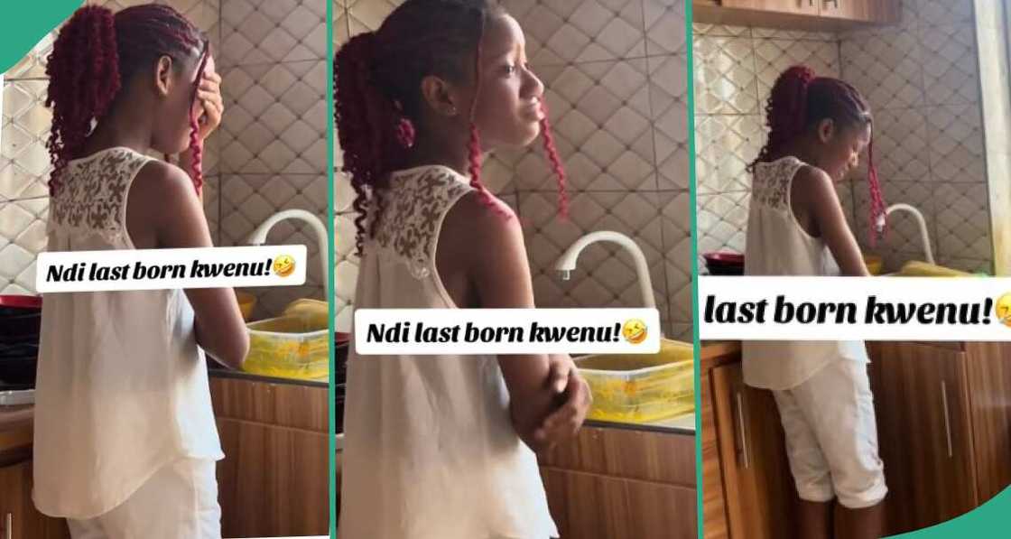 Last born cries in kitchen as she looks at dirty plates in sink Last born cries in kitchen as she looks at dirty plates in sink