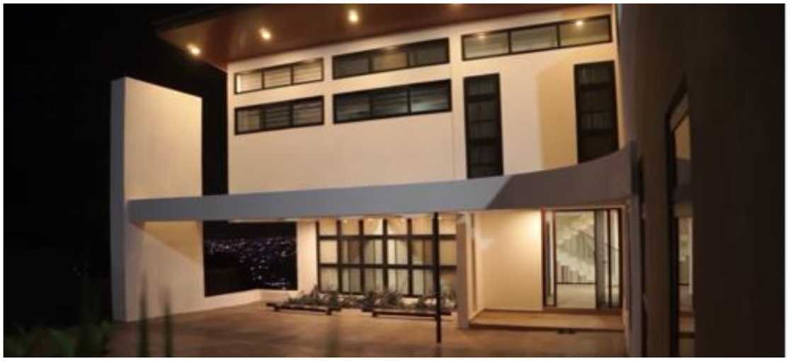 A view of the carport and the window of the sunken living room