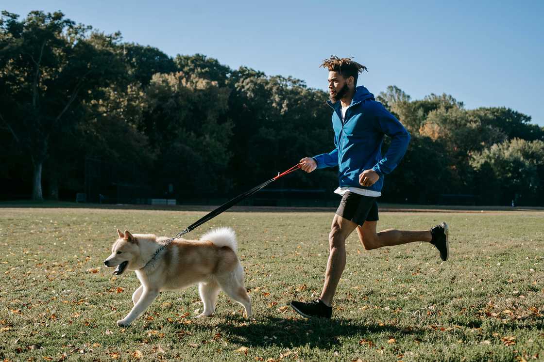 A man running with his dog