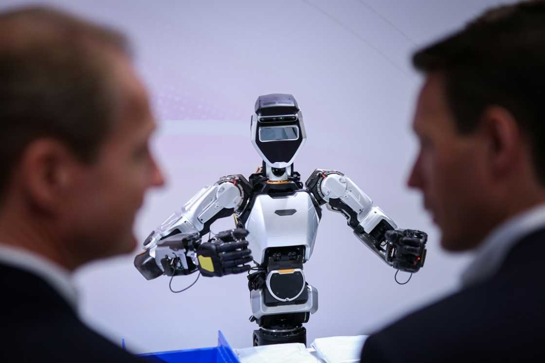Visitors examine a humanoid robot at the booth of Microsoft and Sanctuary AI Visitors examine a humanoid robot at the booth of Microsoft and Sanctuary AI