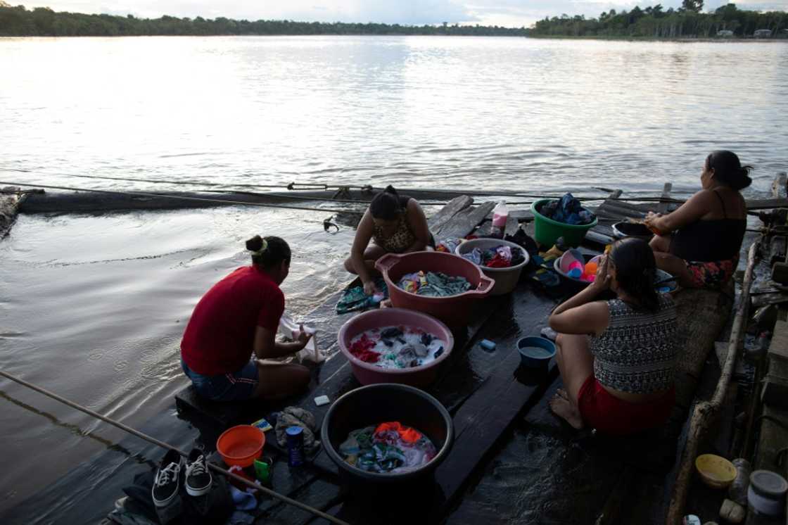 Women wash clothes on the banks of the Javari river in Atalaia do Norte, a town beset with crime Women wash clothes on the banks of the Javari river in Atalaia do Norte, a town beset with crime