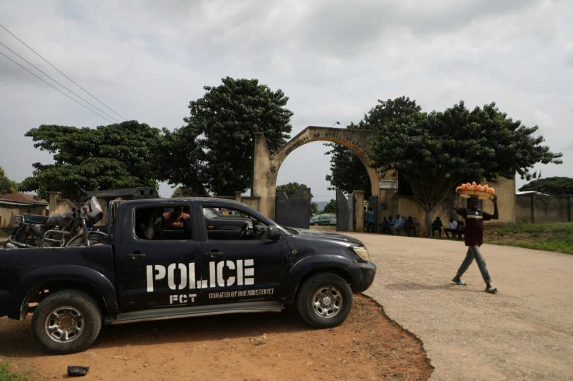 A police truck stands outside the University of Abuja staff Quarters gate where gunmen kidnapped university professors, lecturers and family members on November 2, 2021 A police truck stands outside the University of Abuja staff Quarters gate where gunmen kidnapped university professors, lecturers and family members on November 2, 2021