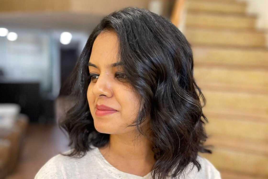 A woman is rocking a wavy black lob