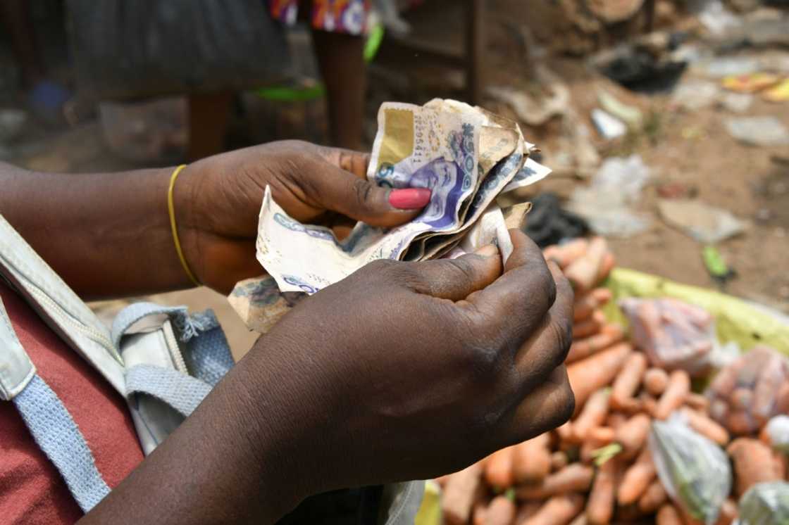Many Nigerians struggled with the cash shortages, as they rely on physical naira currency rather than bank cards for markets and transport Many Nigerians struggled with the cash shortages, as they rely on physical naira currency rather than bank cards for markets and transport