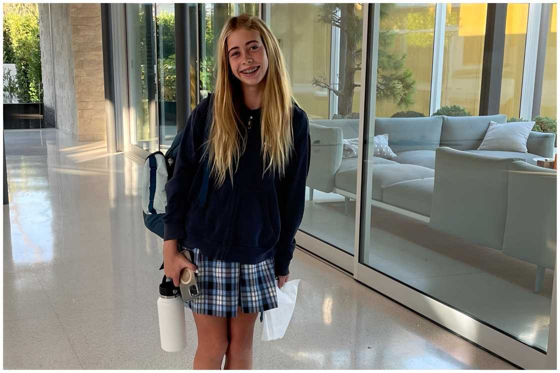 Taylor poses for a photo in a school uniform Taylor poses for a photo in a school uniform