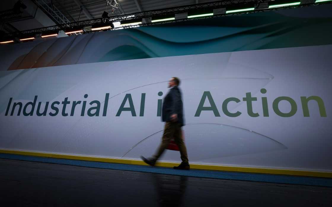 A visitor walks past a sign reading 'Industrial AI in Action' during the opening of the Hannover Messe A visitor walks past a sign reading 'Industrial AI in Action' during the opening of the Hannover Messe