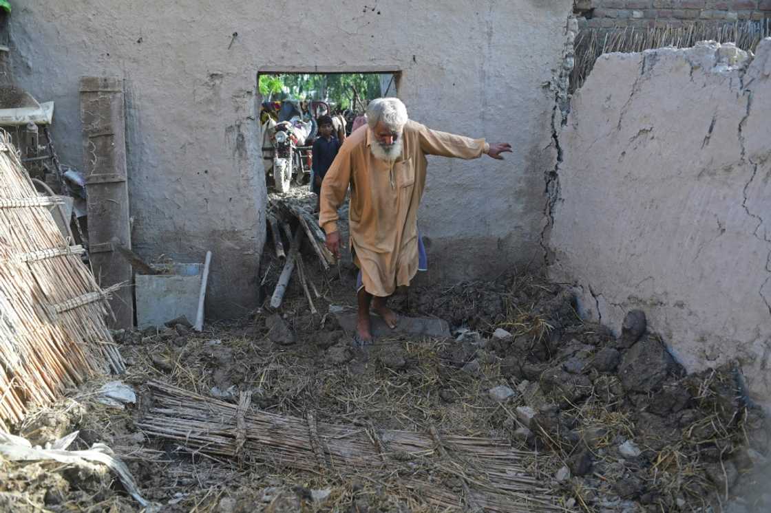 Ghulam Rasool treads through what remains of his flood-damaged mud house on the outskirts of Sukkur in Sindh province Ghulam Rasool treads through what remains of his flood-damaged mud house on the outskirts of Sukkur in Sindh province