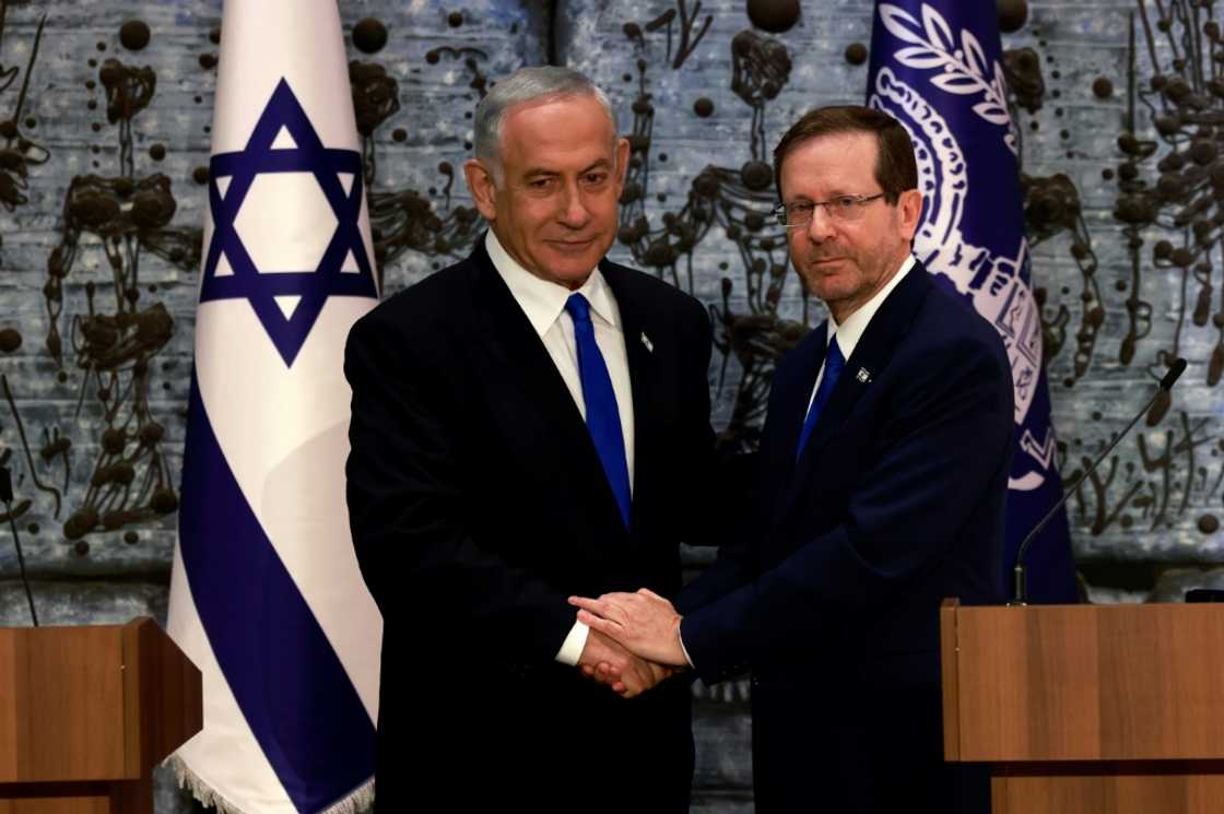 Israeli ex-premier Benjamin Netanyahu, on the left, was mandated with forming a new government by President Isaac Herzog Israeli ex-premier Benjamin Netanyahu, on the left, was mandated with forming a new government by President Isaac Herzog