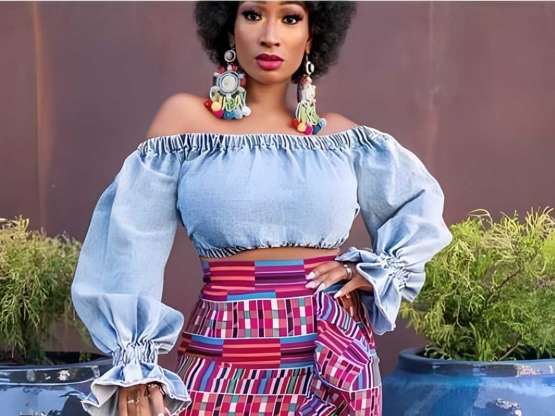 A woman is rocking an off-shoulder and crop denim top A woman is rocking an off-shoulder and crop denim top