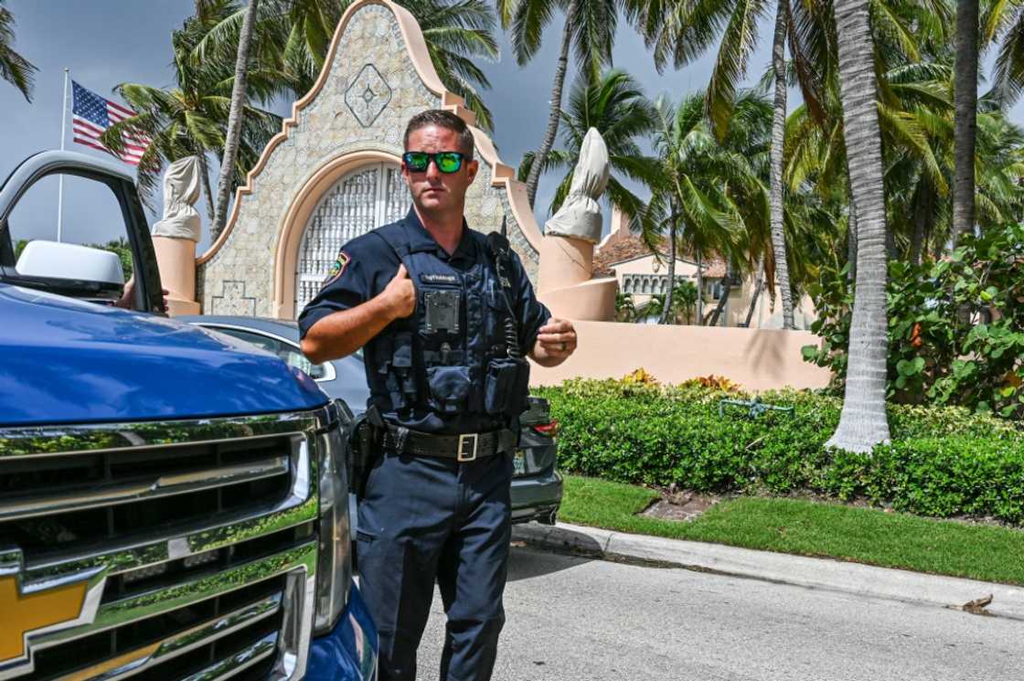 Local law enforcement officers are seen in front of the home of former President Donald Trump at Mar-A-Lago in Palm Beach, Florida on August 9, 2022 Local law enforcement officers are seen in front of the home of former President Donald Trump at Mar-A-Lago in Palm Beach, Florida on August 9, 2022