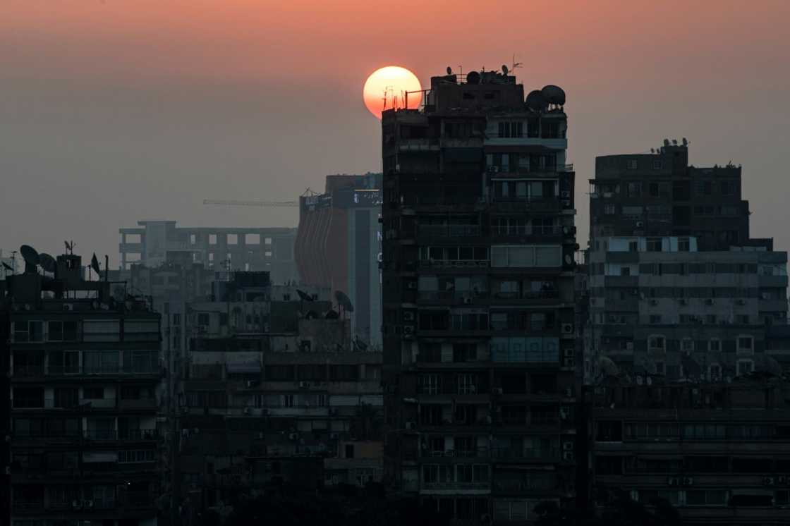 The sun rises behind the skyline of Egypt's capital Cairo and its Nile river island of Manial The sun rises behind the skyline of Egypt's capital Cairo and its Nile river island of Manial