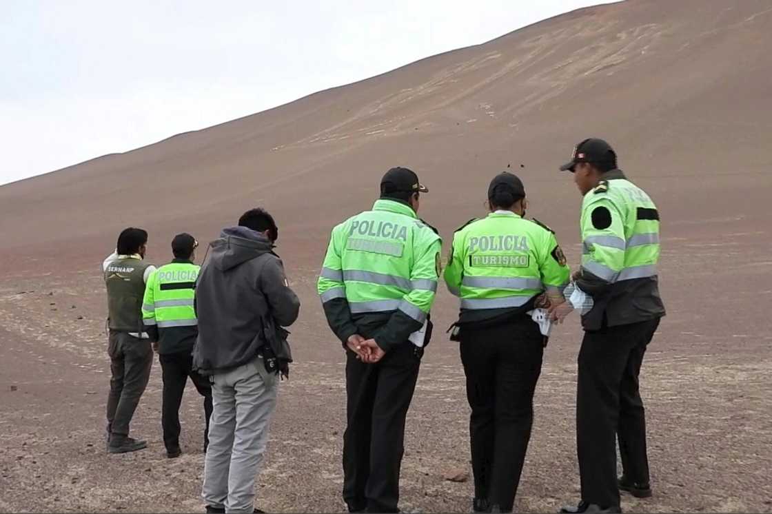 A frame grab from a video courtesy of the Peruvian Ministry of Culture shows police examining the damage at the Paracas Candelabra A frame grab from a video courtesy of the Peruvian Ministry of Culture shows police examining the damage at the Paracas Candelabra