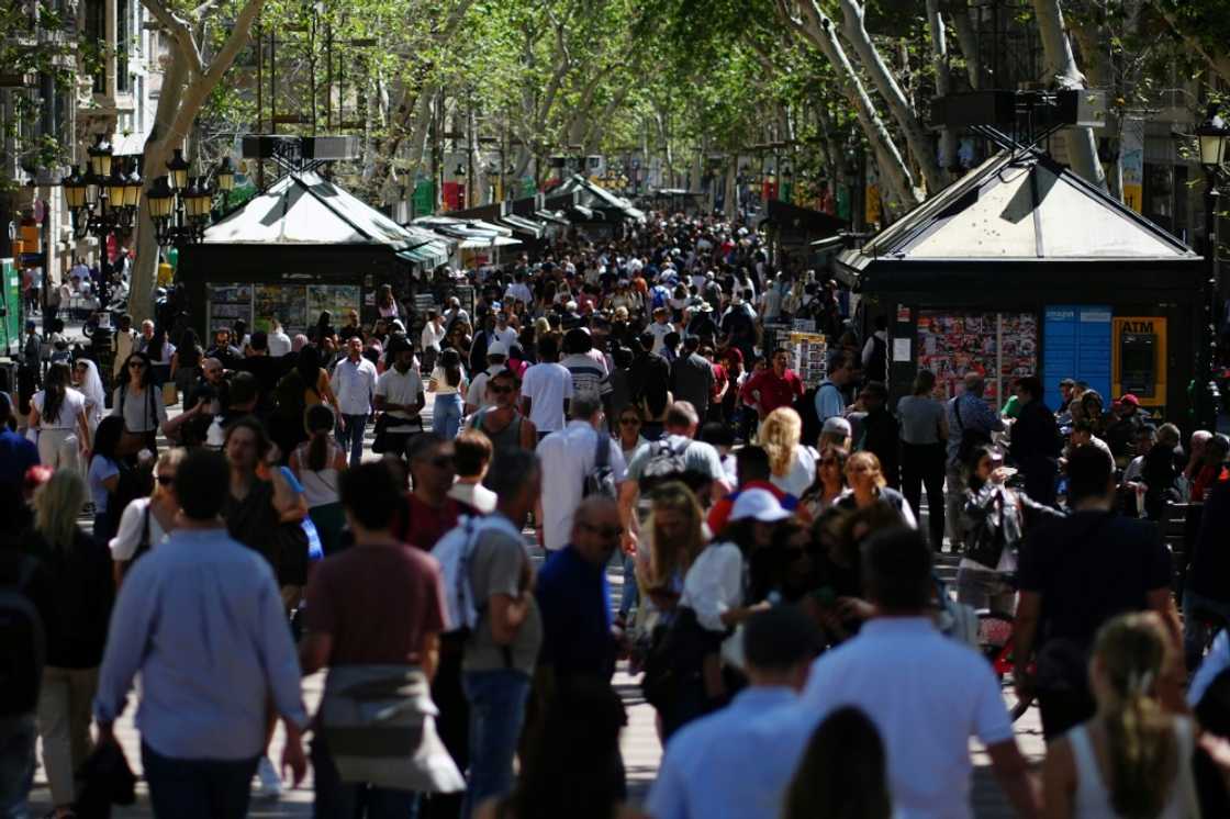 Tourists crowd Las Ramblas alley in Barcelona Tourists crowd Las Ramblas alley in Barcelona