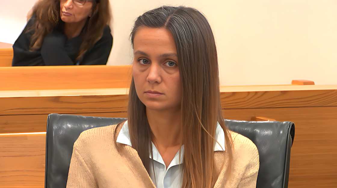 Ashley Benefield seated in court wearing a beige sweater and blue collared shirt. Ashley Benefield seated in court wearing a beige sweater and blue collared shirt.