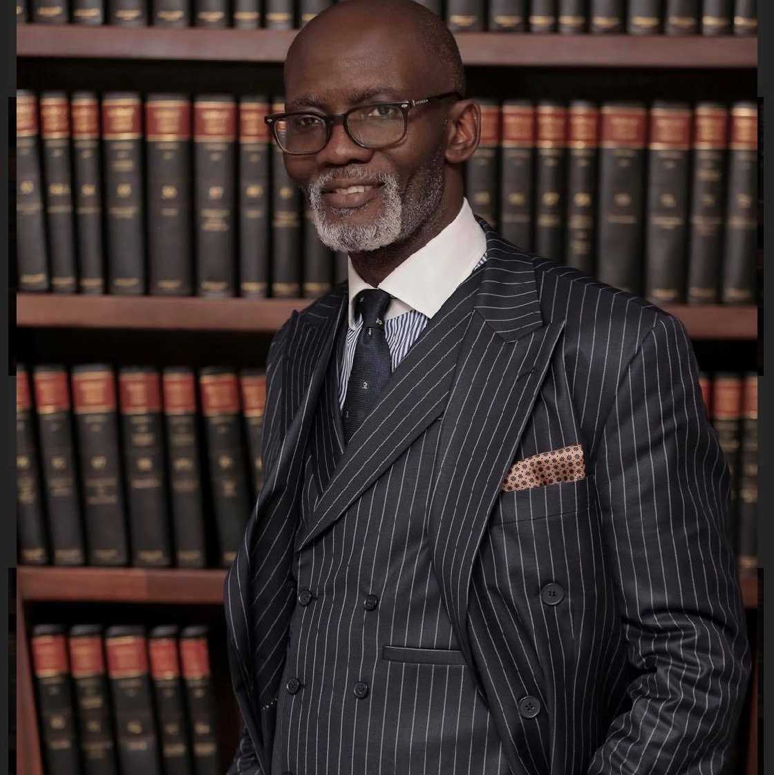 Gabby Otchere-Darko posses in front of some law books.