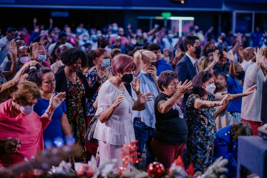 Men and women in church praying.