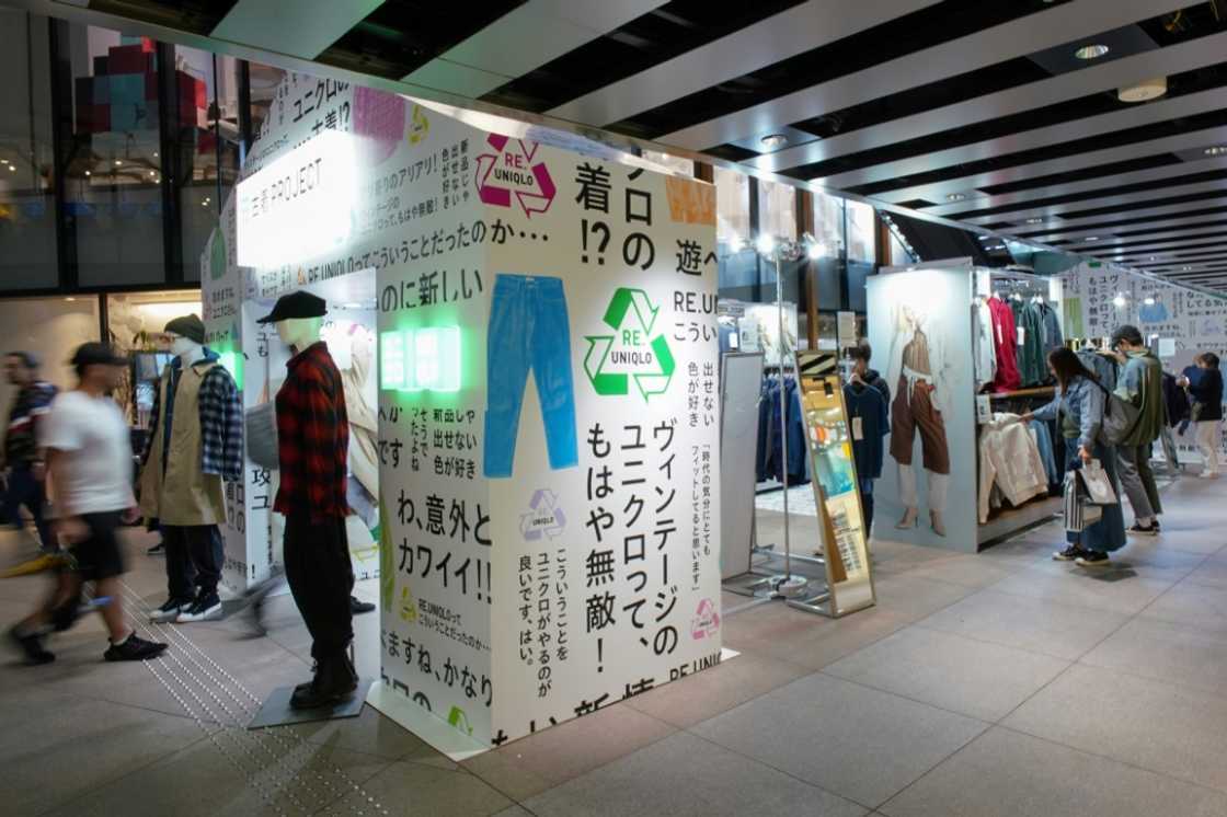 Customers browse through items sold as part of the Uniqlo Pre-owned Clothes Project at the brand's Harajuku store in Tokyo Customers browse through items sold as part of the Uniqlo Pre-owned Clothes Project at the brand's Harajuku store in Tokyo