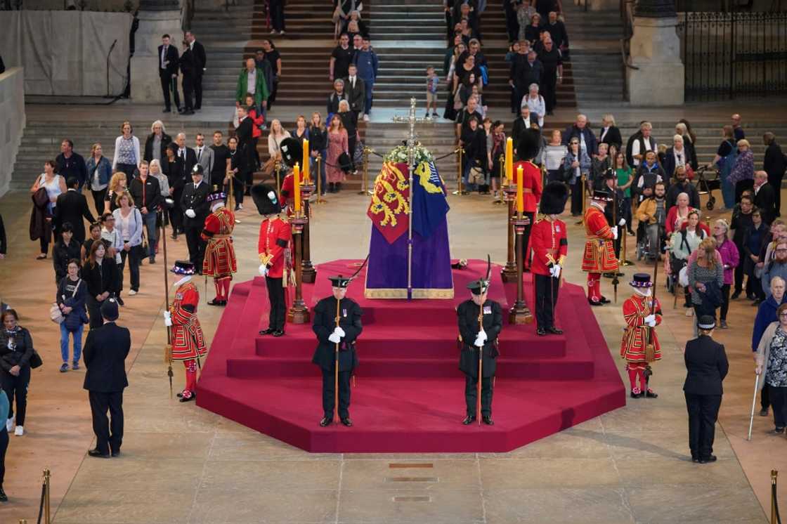 Mourners have marked their moment in front of the coffin in various ways, from bows or curtsies to the sign of the cross or by simply removing their hats Mourners have marked their moment in front of the coffin in various ways, from bows or curtsies to the sign of the cross or by simply removing their hats