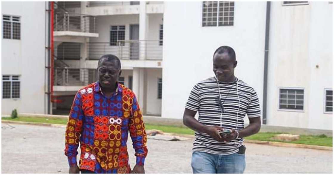 The Deputy Lands Minister (left) inspects the project