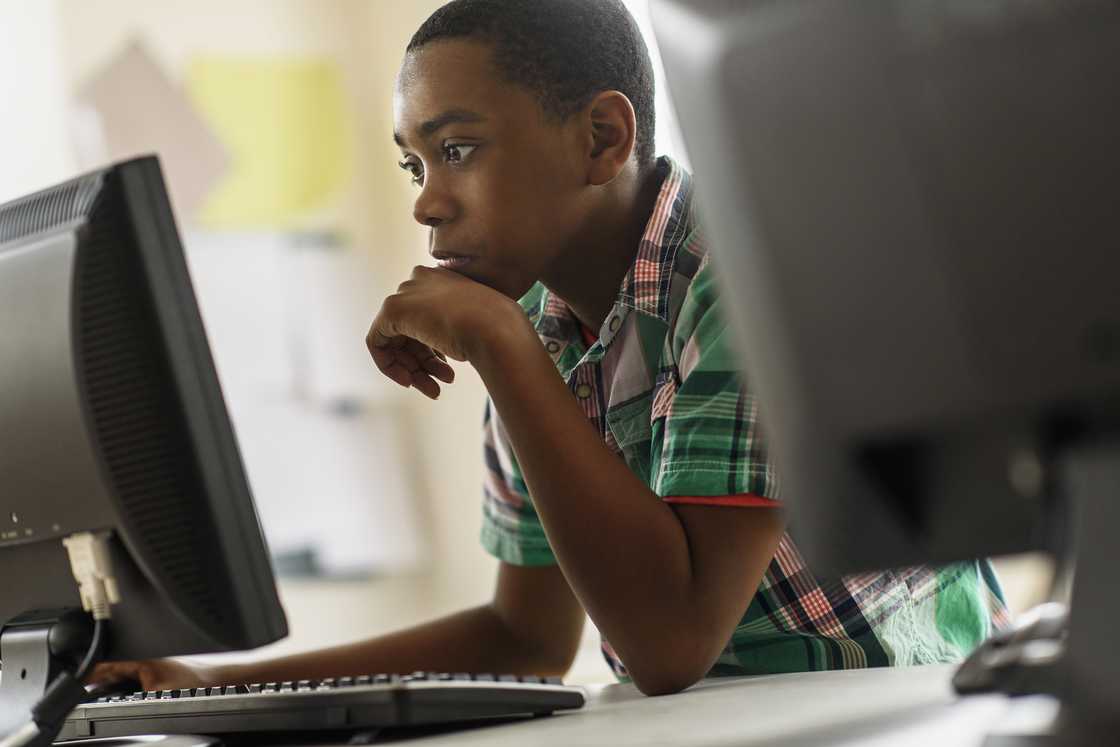 Black students using computers in classroom