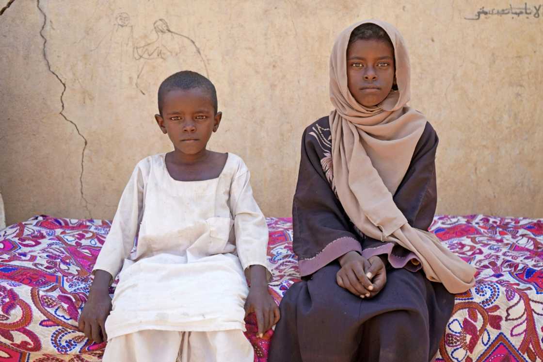 Zahra Hussein, aged nine, forced to stay home helping out with household chores as money grew ever tighter, poses with her brother in eastern Sudanese village of Ed Moussa Zahra Hussein, aged nine, forced to stay home helping out with household chores as money grew ever tighter, poses with her brother in eastern Sudanese village of Ed Moussa