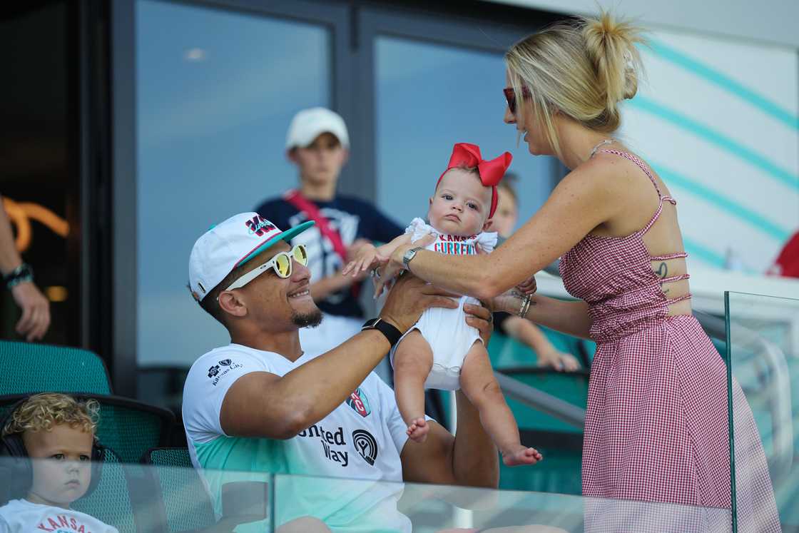 Patrick Mahomes and Brittany Mahomes with their child