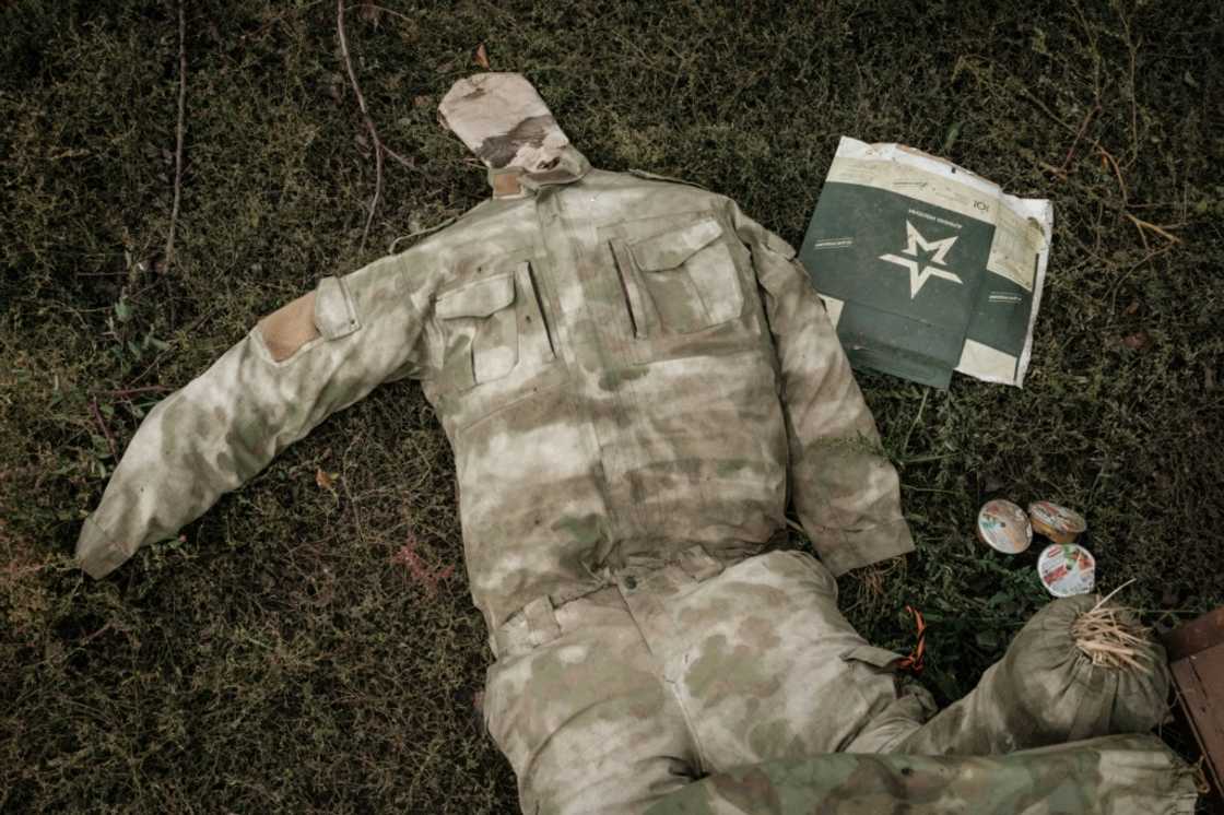 A stuffed Russian army uniform lies on the gound near a suspected mass grave in Kozacha Lopan in eastern Ukraine A stuffed Russian army uniform lies on the gound near a suspected mass grave in Kozacha Lopan in eastern Ukraine
