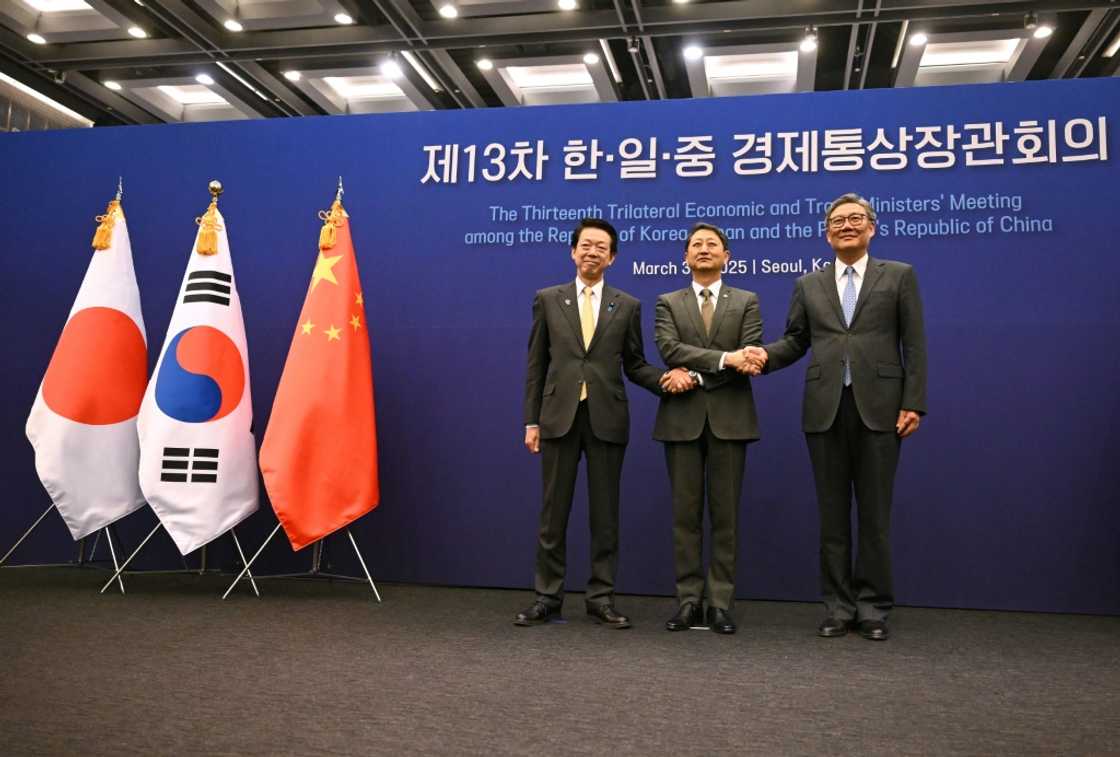 South Korea's Trade, Industry and Energy Minister Ahn Duk-geun (centre) poses for a photo with Japan's Economy, Trade and Industry Minister Yoji Muto (left) and China's Commerce Minister Wang Wentao in Seoul South Korea's Trade, Industry and Energy Minister Ahn Duk-geun (centre) poses for a photo with Japan's Economy, Trade and Industry Minister Yoji Muto (left) and China's Commerce Minister Wang Wentao in Seoul
