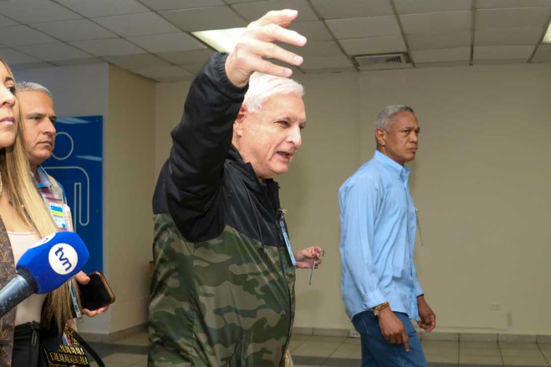Former Panamanian president Ricardo Martinelli gestures before the arrival of his two sons, Luis Enrique Martinelli and Ricardo Martinelli Jr, in Panama City after they were released from a US prison where they served time for corruption Former Panamanian president Ricardo Martinelli gestures before the arrival of his two sons, Luis Enrique Martinelli and Ricardo Martinelli Jr, in Panama City after they were released from a US prison where they served time for corruption