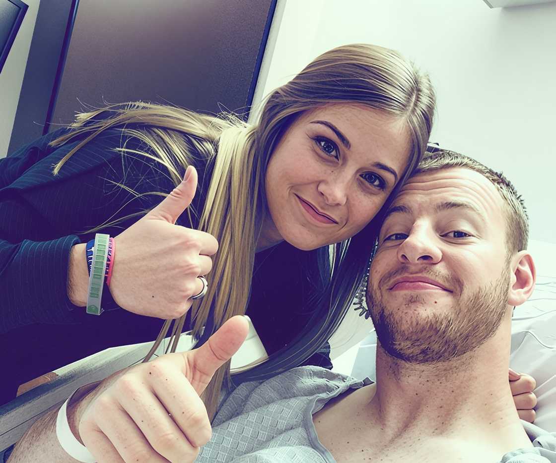 Carson Wentz and Madison Oberg smile and give thumbs-up in a hospital room.
