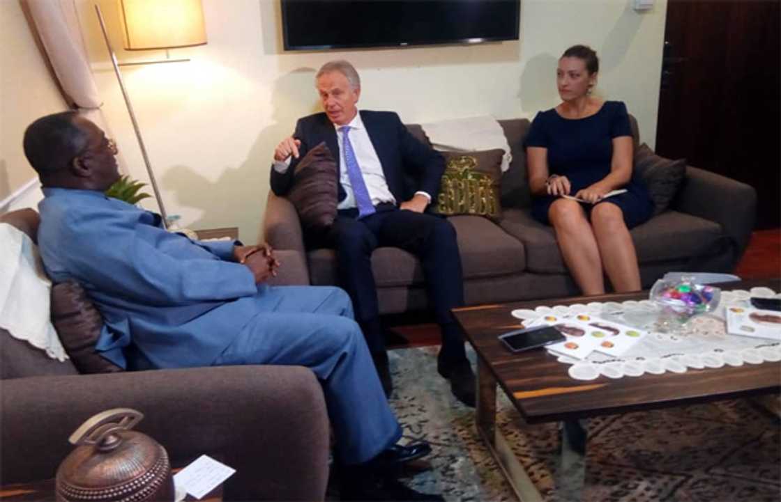 Three people seated in a room Three people seated in a room