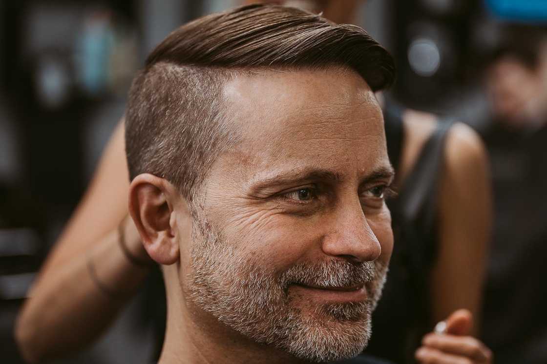 An older man is rocking a disconnected undercut with a beard An older man is rocking a disconnected undercut with a beard
