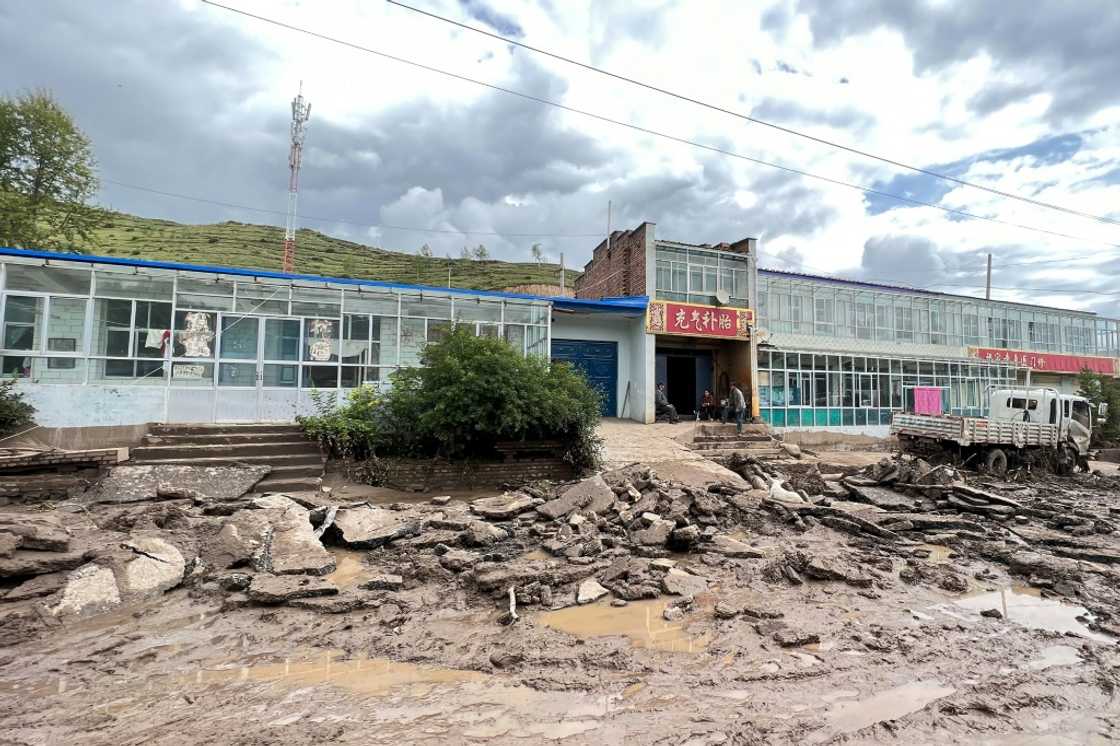 A road is damaged after a flash flooding caused by a sudden downpour triggered mudslides in Datong county, Xining city, in China's northwestern Qinghai province on August 18 A road is damaged after a flash flooding caused by a sudden downpour triggered mudslides in Datong county, Xining city, in China's northwestern Qinghai province on August 18