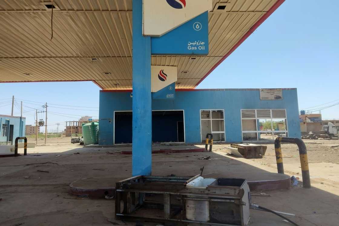 A broken and looted petrol station in southern Khartoum -- even if truckers find fuel, they must pay inflated prices A broken and looted petrol station in southern Khartoum -- even if truckers find fuel, they must pay inflated prices