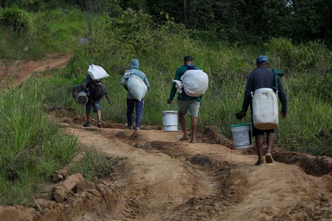 Alleged illegal miners leave a mining area inside Yanomami indigenous land Alleged illegal miners leave a mining area inside Yanomami indigenous land