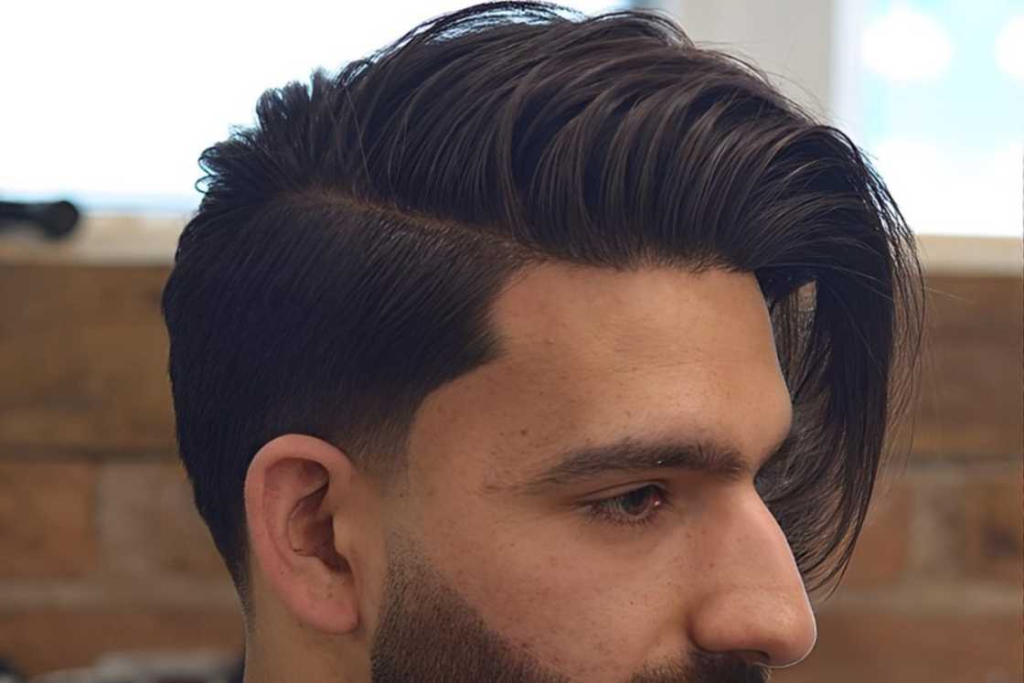 A white man is rocking a medium side-swept taper A white man is rocking a medium side-swept taper