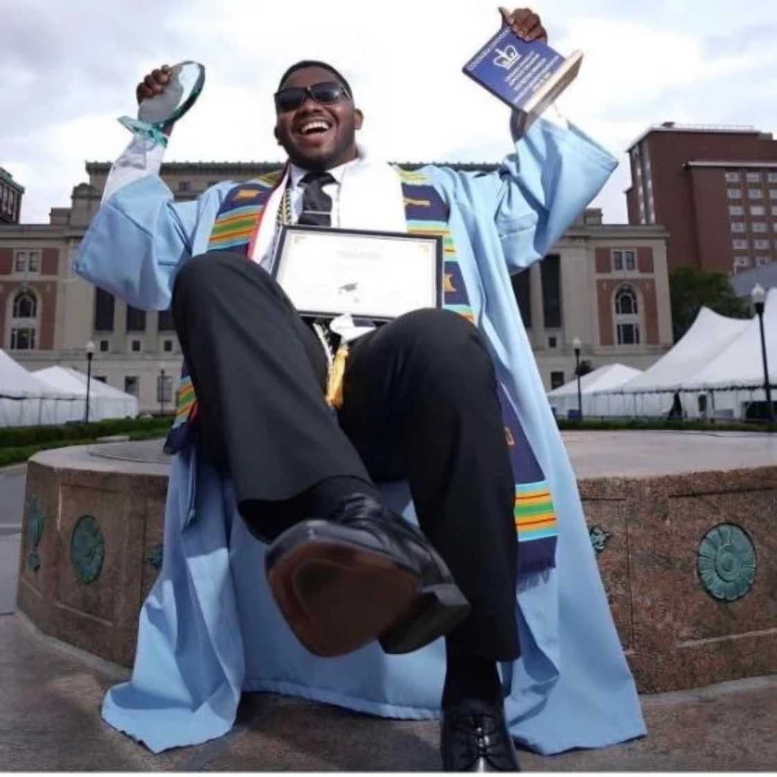 Sylvester Benson displays his honours and awards at his graduation from Columbia University.