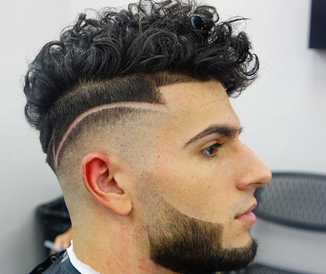 Black undercut with a shaved design Black undercut with a shaved design