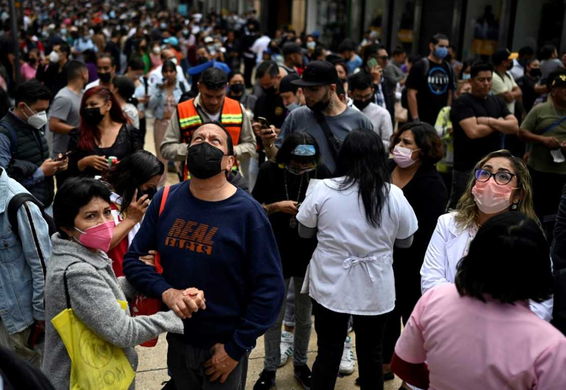 People wait on the streets of Mexico City after a powerful earthquake