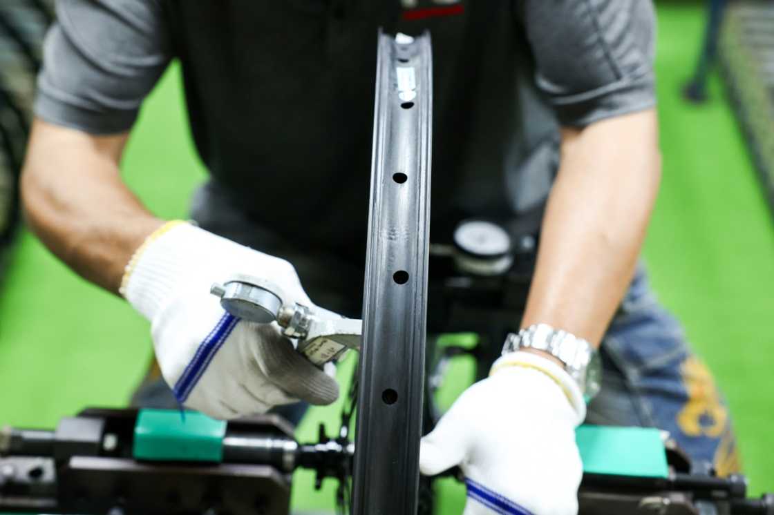 A worker tests a bicycle wheel at a factory of Joy Group in Taichung on April 24, 2025 A worker tests a bicycle wheel at a factory of Joy Group in Taichung on April 24, 2025