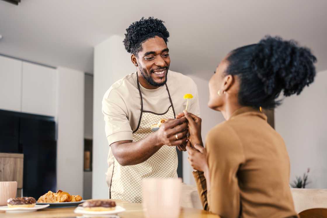 Loving couple enjoying romantic morning breakfast at home