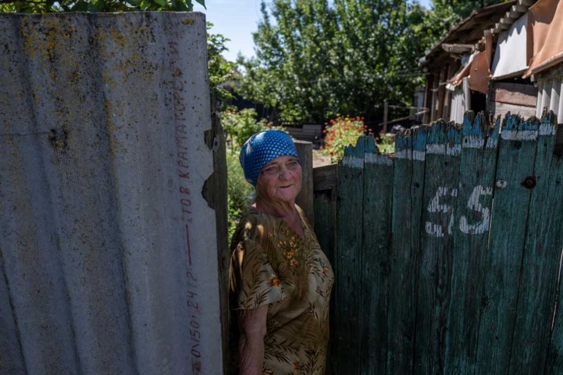 A woman in front of her house in Donbas region, amid Russia's military invasion of Ukraine A woman in front of her house in Donbas region, amid Russia's military invasion of Ukraine