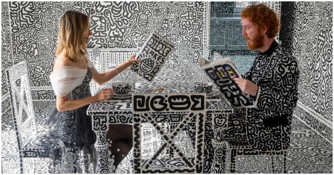 The couple sit at the dining area The couple sit at the dining area