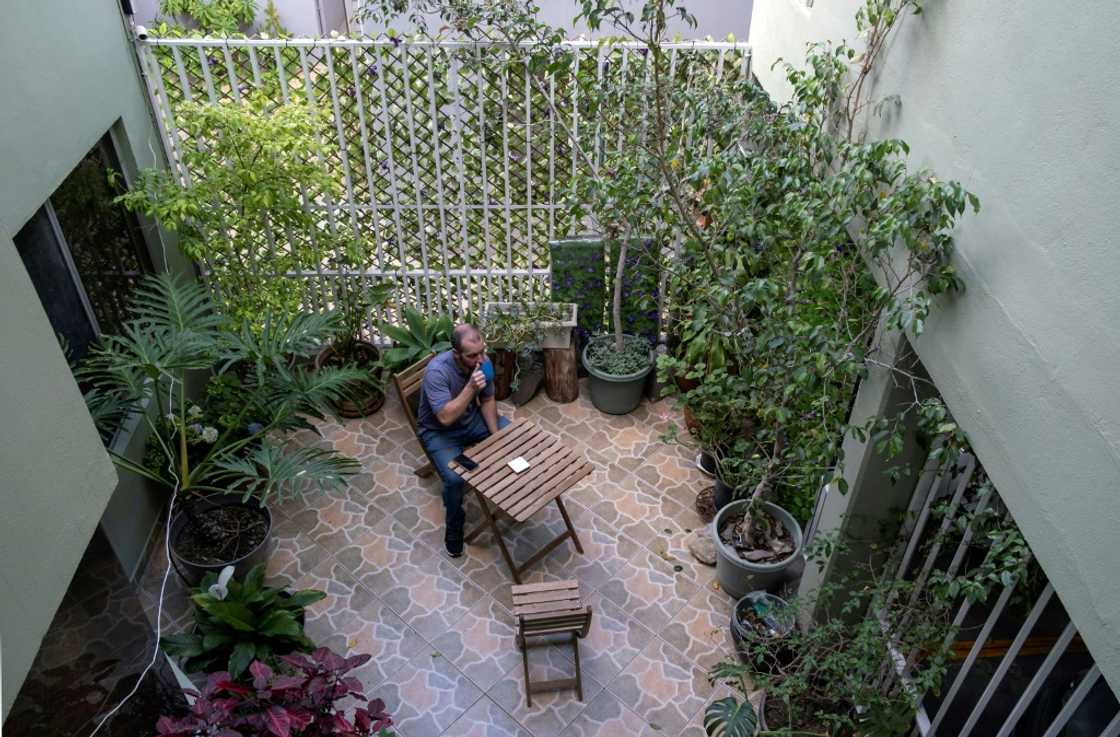 Mike Rachfal, a US teacher living in Mexico, drinks a coffee in his apartment building in the border city of Tijuana