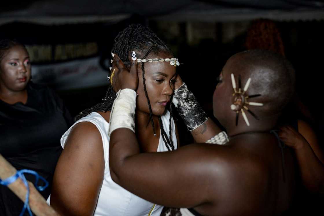 A designer fits a model backstage during for the show A designer fits a model backstage during for the show