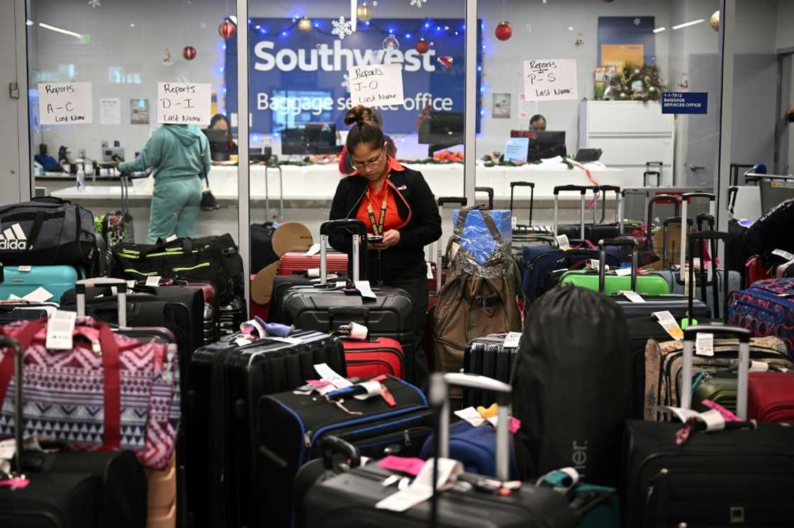 A Southwest Airlines ground crew member, photographed on December 28, 2022, is shown organizing unclaimed luggage at Los Angeles International Airport A Southwest Airlines ground crew member, photographed on December 28, 2022, is shown organizing unclaimed luggage at Los Angeles International Airport